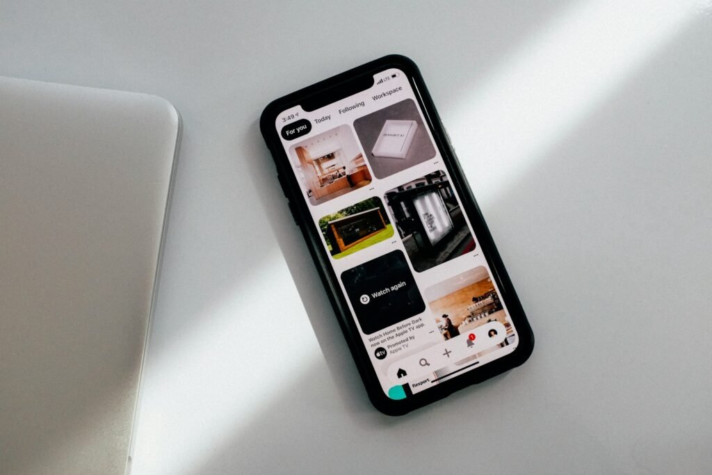 A smartphone lying face up on a quiet white desk