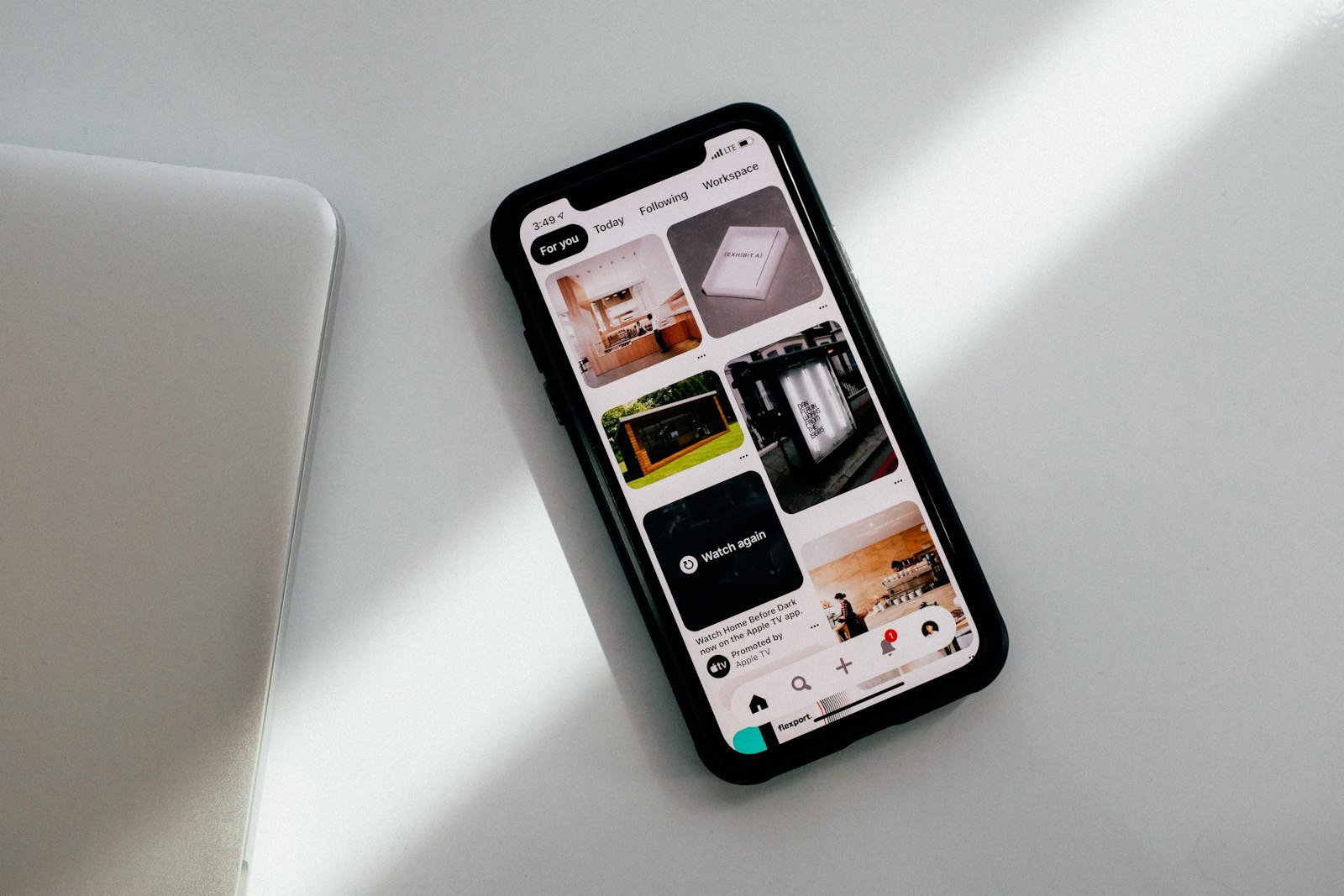 A smartphone lying face up on a quiet white desk